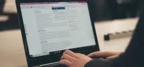 person typing on laptop computer