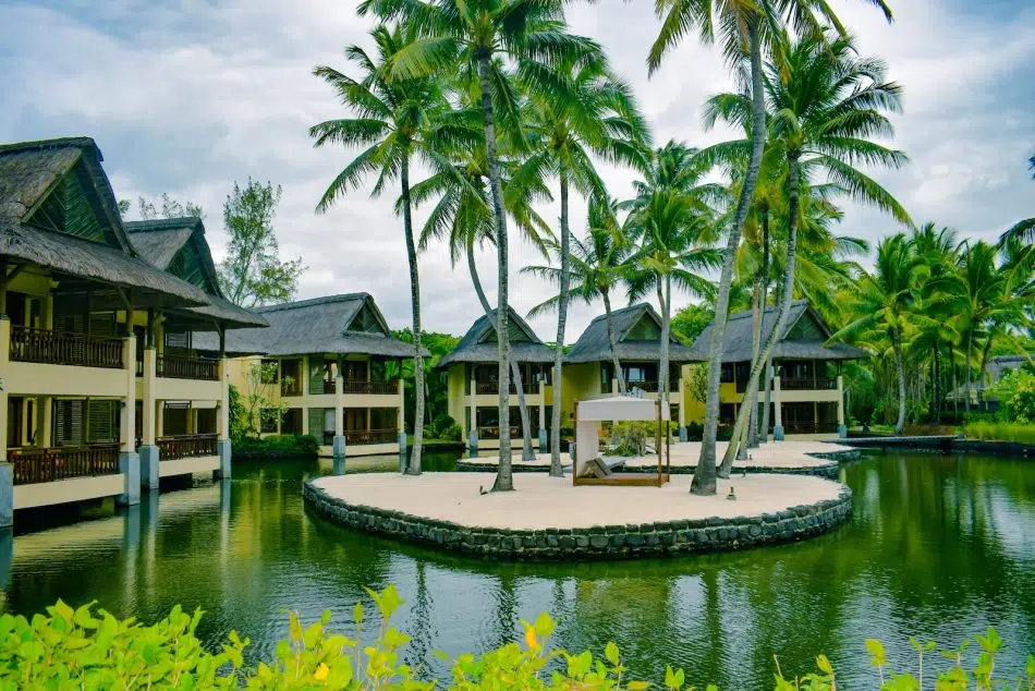 brown and white wooden house near body of water during daytime