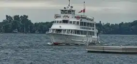 white boat on body of water at daytime